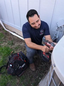 Nathaniel Segura doing repairs on a AC unit