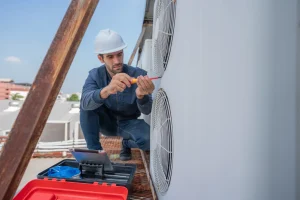 hvac worker performing maintenance on ac unit